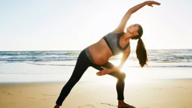 Pregnant woman practicing yoga outdoors